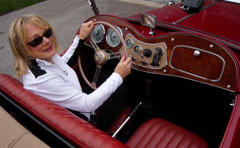 Carol Patterson in the driver seat of her car, Lulu